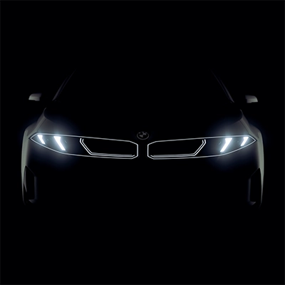 2027 BMW i3 Sedan front with illuminated headlights at night