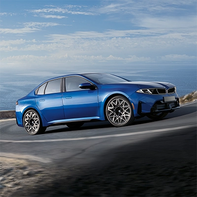 2027 BMW i3 Sedan cornering on a coastal road